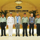 Mao Xinyu, extreme left, and other military officials at the China State Shipbuilding Corporation on Friday.